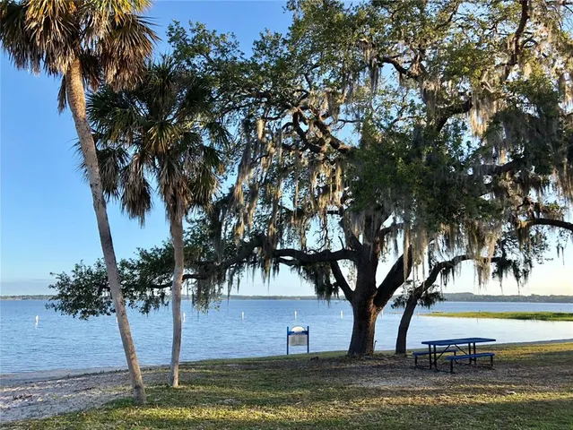 a view of a swimming pool with an outdoor seating and a yard