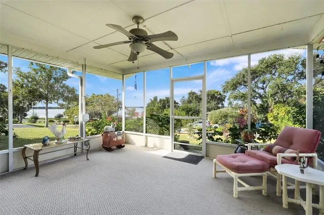 a living room with patio furniture and a potted plants