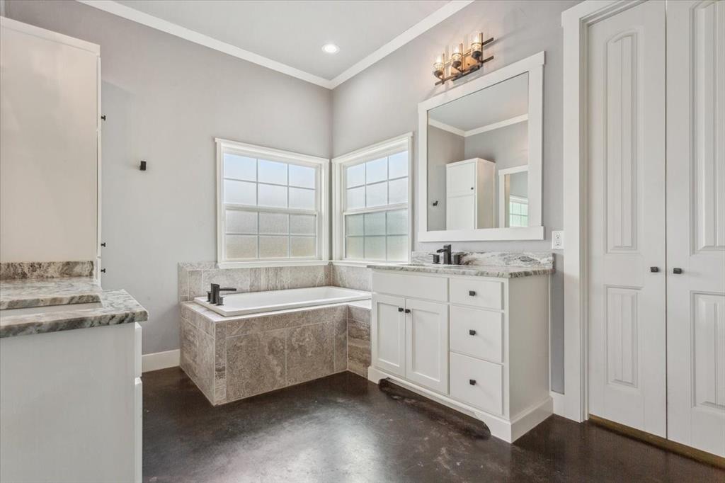 259 County Road 149 Riesel, TX 76682 - Photo 20 of 40 Full bath featuring crown molding, concrete floors, a garden tub, vanity, and baseboards
