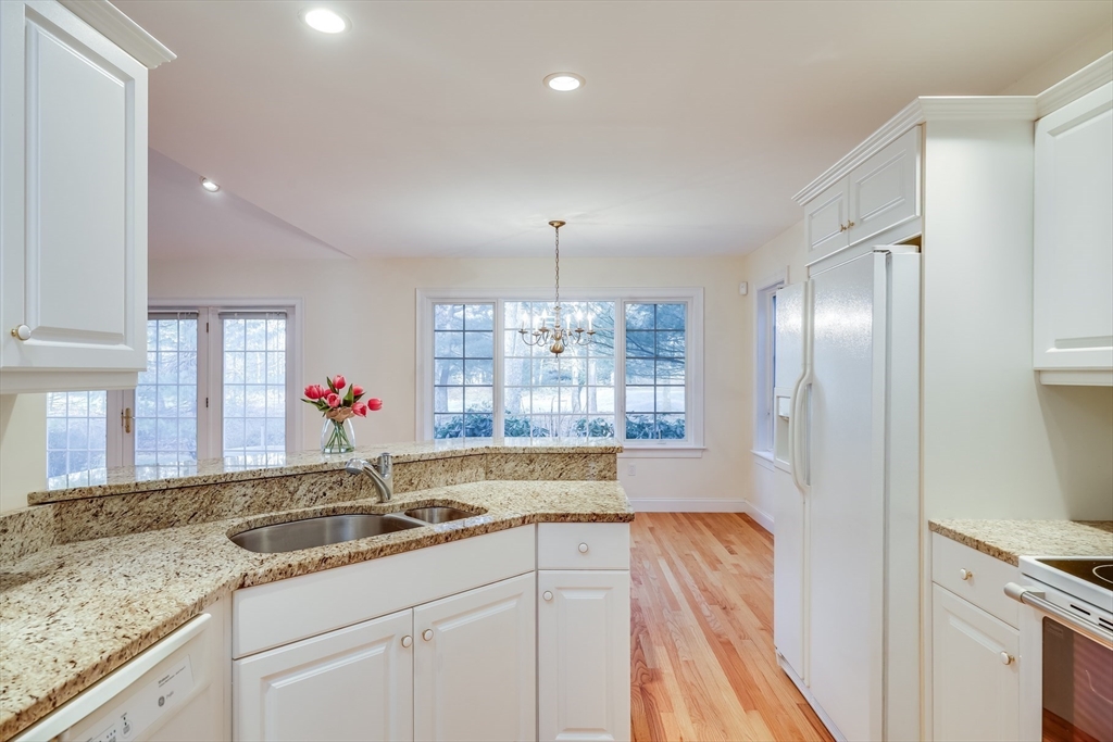 91 Reflection Drive Sandwich, MA 02563 - Photo 11 of 42 a kitchen with granite countertop a sink stainless steel appliances and cabinets
