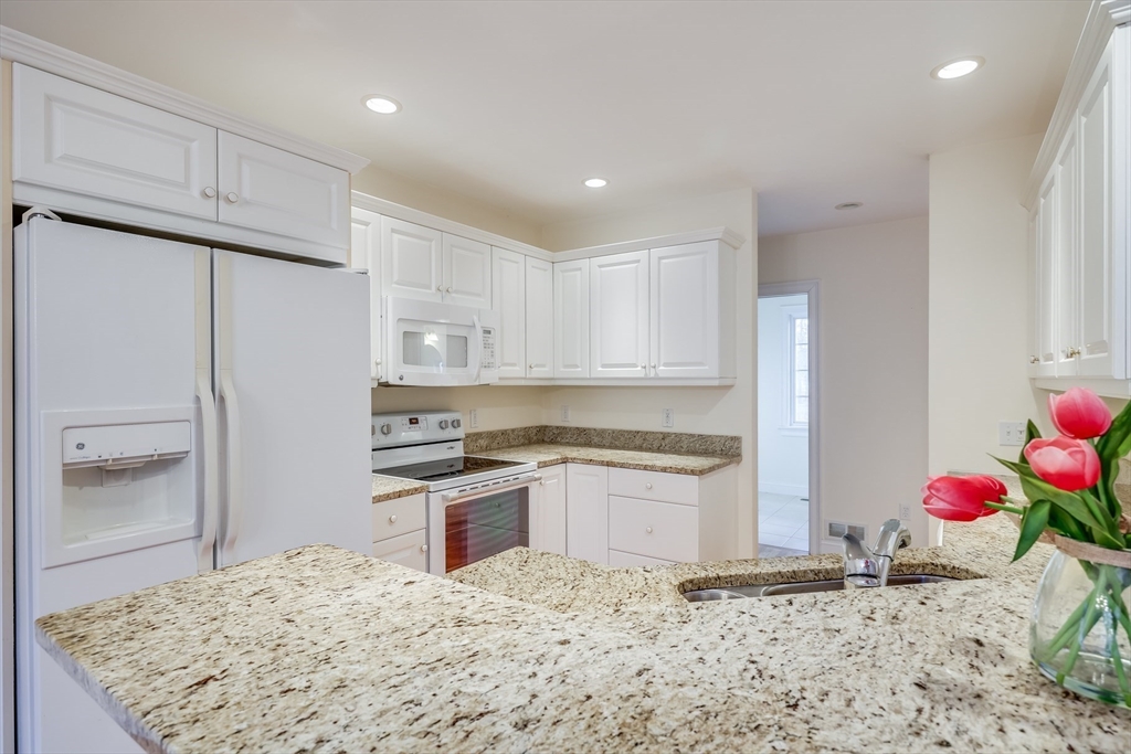 91 Reflection Drive Sandwich, MA 02563 - Photo 12 of 42 a kitchen with granite countertop cabinets and stainless steel appliances