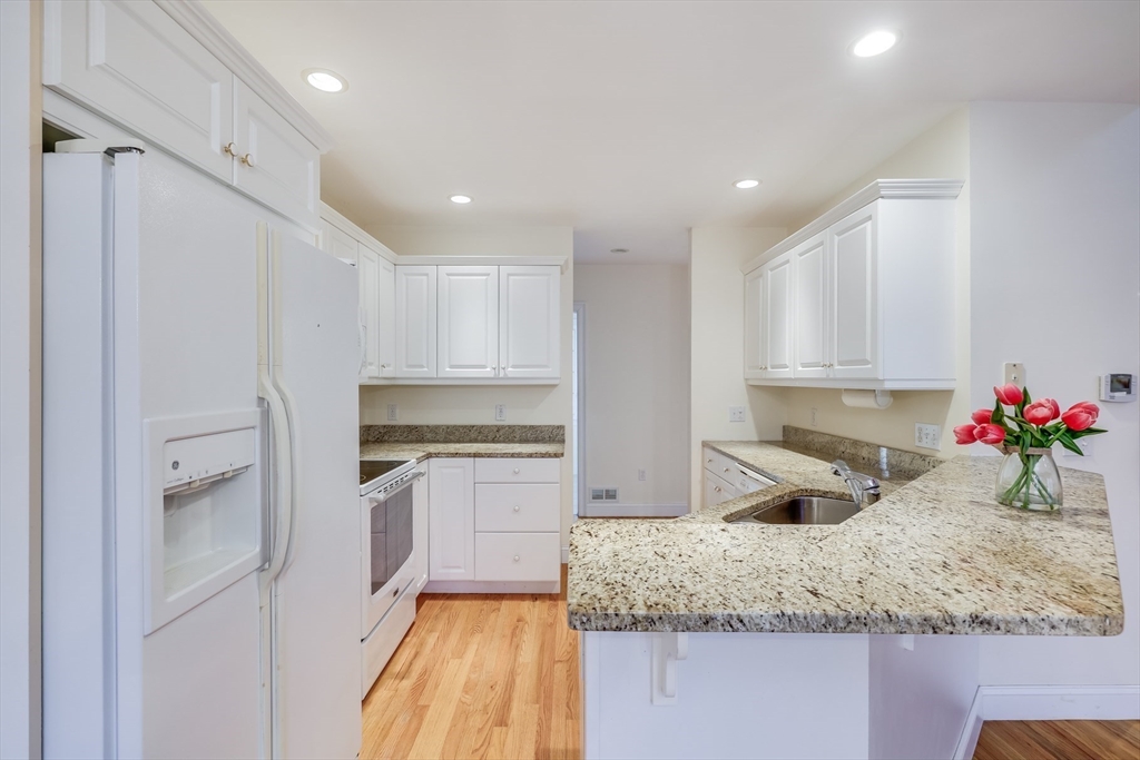 91 Reflection Drive Sandwich, MA 02563 - Photo 13 of 42 a kitchen with granite countertop cabinets and oven