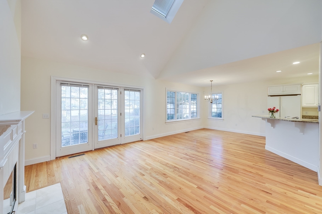 91 Reflection Drive Sandwich, MA 02563 - Photo 14 of 42 a view of an empty room with wooden floor and a window