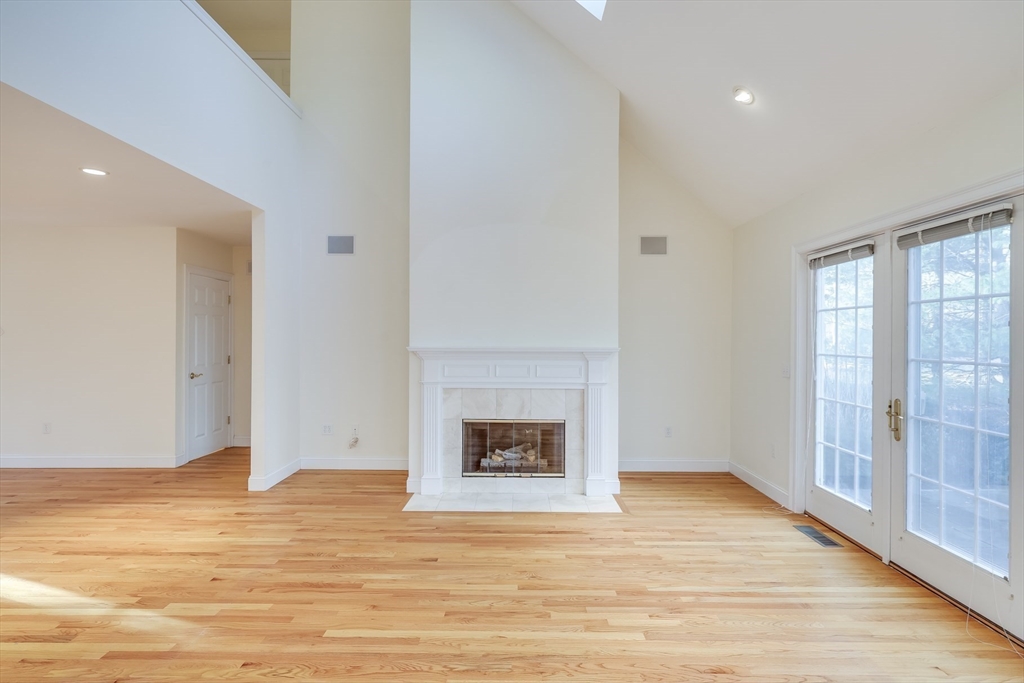 91 Reflection Drive Sandwich, MA 02563 - Photo 16 of 42 a view of an empty room with wooden floor and a window