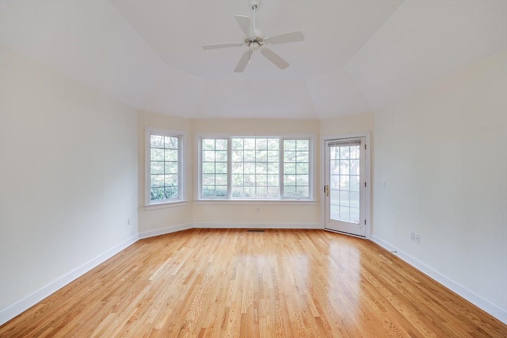91 Reflection Drive Sandwich, MA 02563 - Photo 19 of 42 an empty room with wooden floor and windows