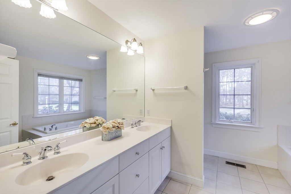 91 Reflection Drive Sandwich, MA 02563 - Photo 20 of 42 a bathroom with a double vanity sink a mirror and a bathtub