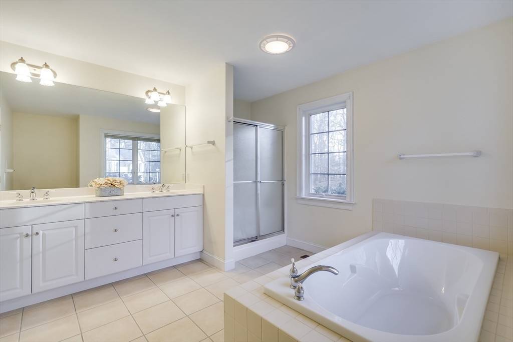 91 Reflection Drive Sandwich, MA 02563 - Photo 21 of 42 a spacious bathroom with a tub sink and mirror