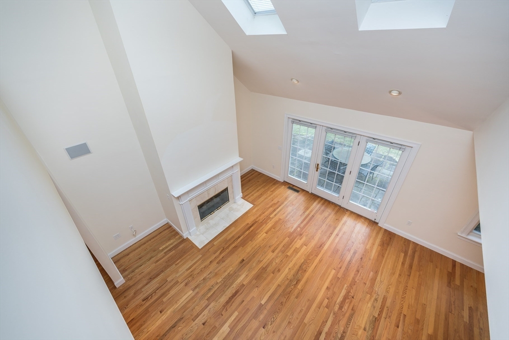 91 Reflection Drive Sandwich, MA 02563 - Photo 29 of 42 a view of an empty room with wooden floor and a window