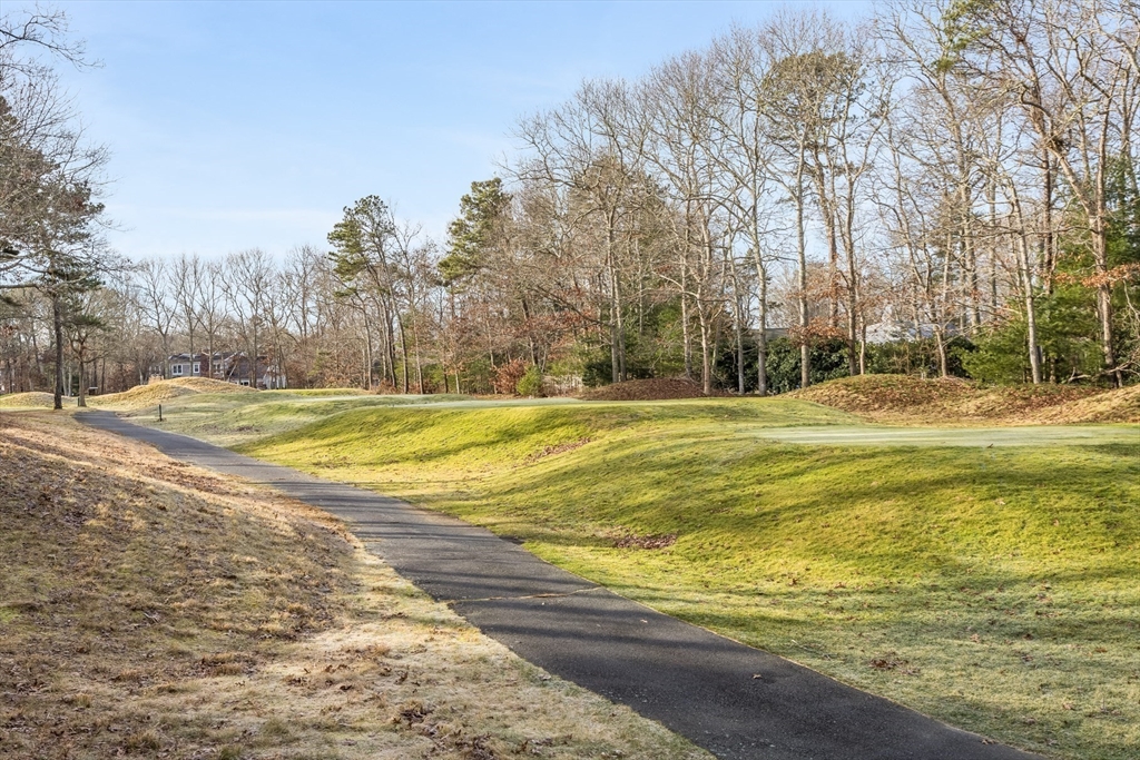 91 Reflection Drive Sandwich, MA 02563 - Photo 36 of 42 a view of a swimming pool with an outdoor space and seating area