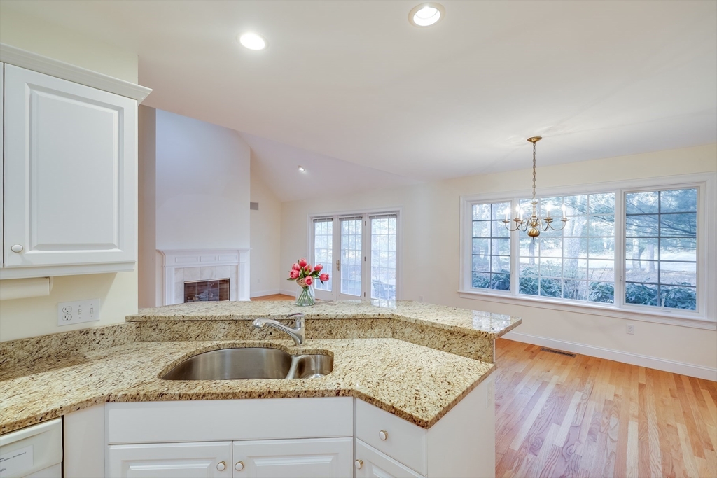 91 Reflection Drive Sandwich, MA 02563 - Photo 7 of 42 a kitchen with a stove sink and cabinets