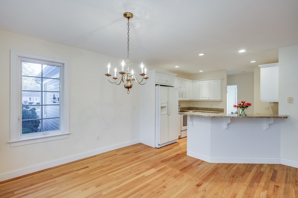 91 Reflection Drive Sandwich, MA 02563 - Photo 8 of 42 a view of a kitchen with kitchen island stainless steel appliances a sink window and wooden floor