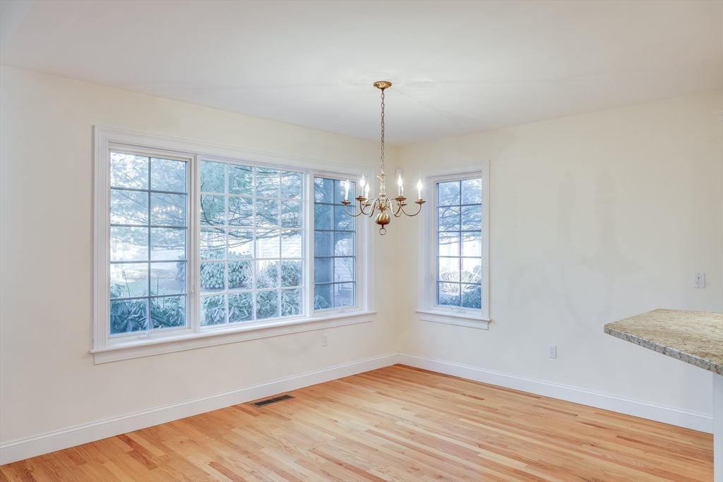 91 Reflection Drive Sandwich, MA 02563 - Photo 9 of 42 a view of an empty room with wooden floor and a window