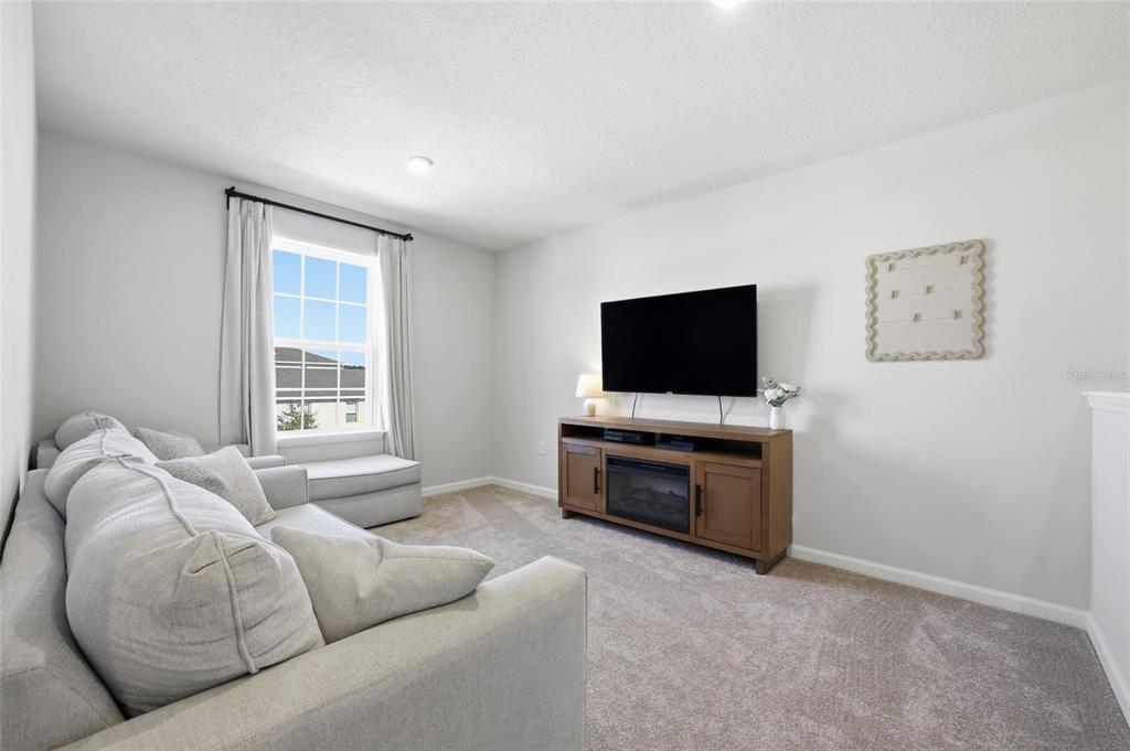 5000 Bear Lake Loop DeLand, FL 32724 - Photo 25 of 45 a living room with furniture and a flat screen tv
