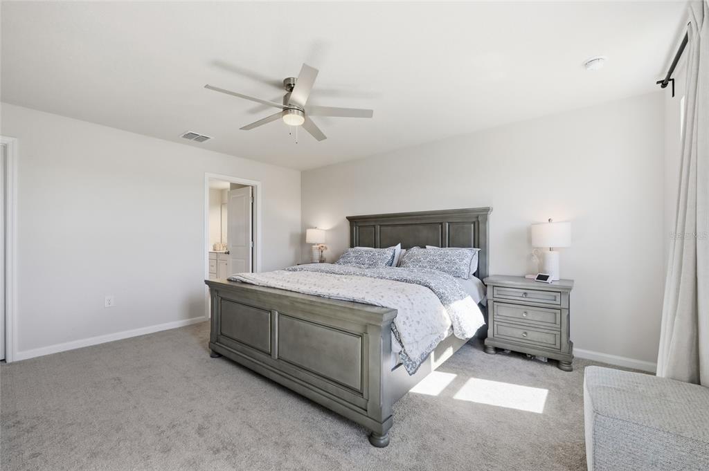 5000 Bear Lake Loop DeLand, FL 32724 - Photo 28 of 45 a bedroom with a bed and cabinets