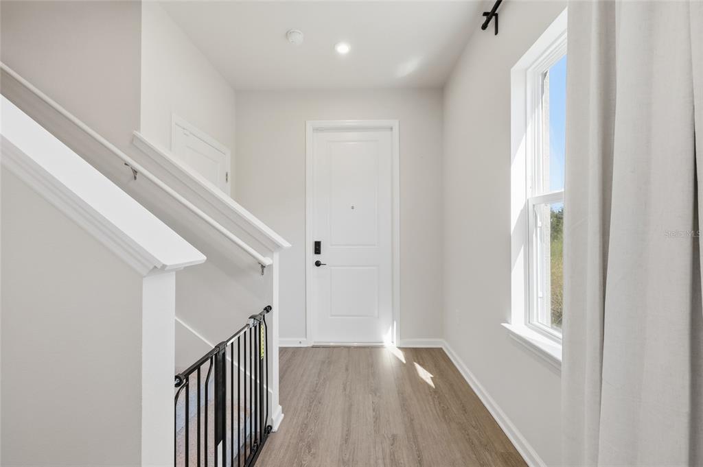 5000 Bear Lake Loop DeLand, FL 32724 - Photo 5 of 45 a view of a hallway with wooden floor and entryway