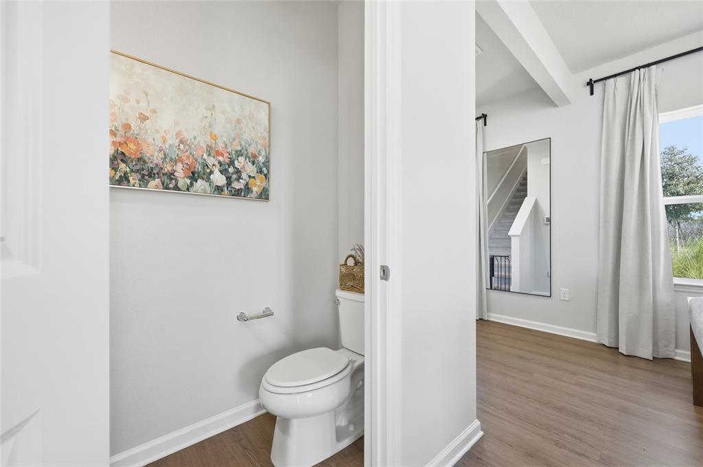 5000 Bear Lake Loop DeLand, FL 32724 - Photo 10 of 45 a bathroom with a toilet and a painting on the wall