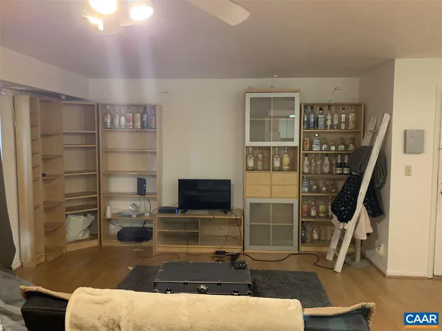 a room with wooden floor and windows