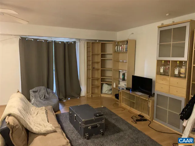 a living room with furniture gym equipment and a flat screen tv