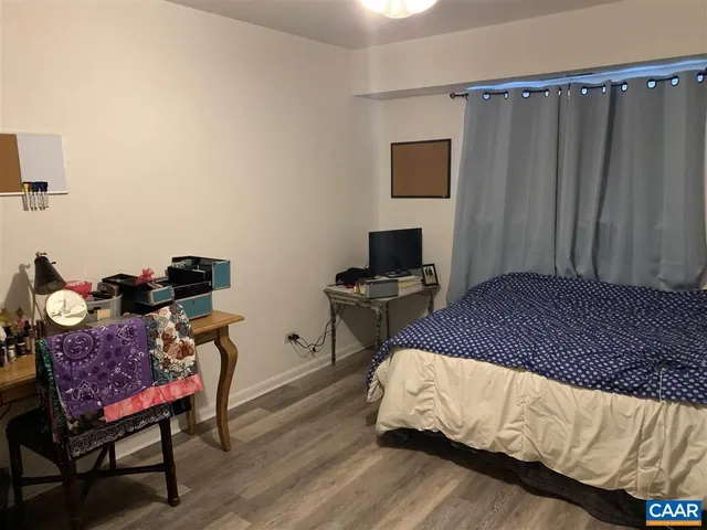 a bedroom with a bed and a tv in it