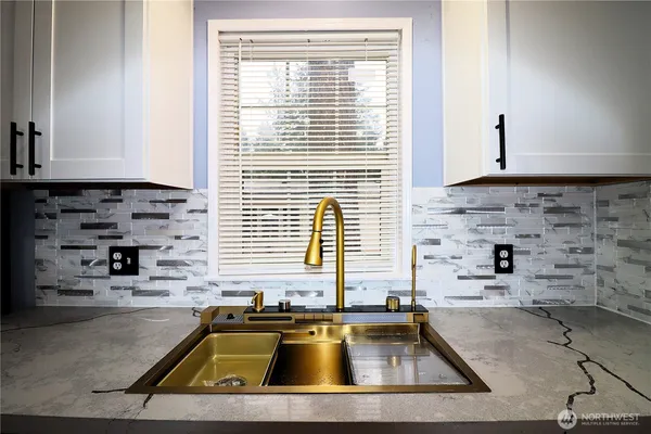 a kitchen with a sink a stove and a window