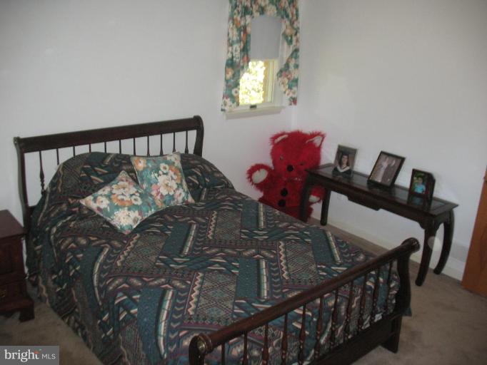 3332 Fallston Road Fallston, MD 21047 - Photo 11 of 15 a bed sitting in a bedroom next to a window with tv on it