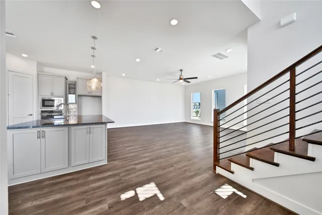 a kitchen with stainless steel appliances granite countertop a refrigerator a sink and a stove