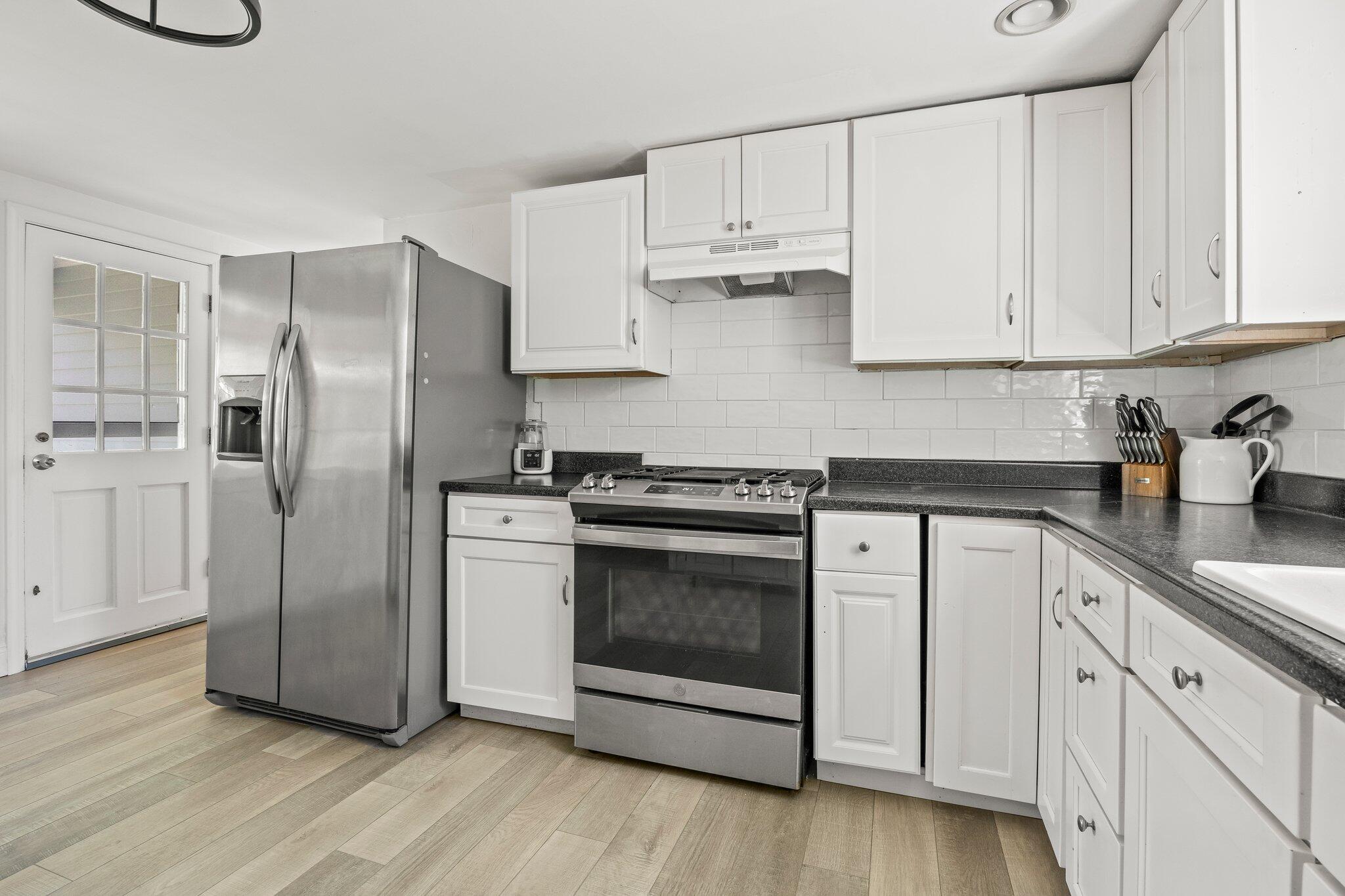 91 Sterling Road Hyannis, MA 02601 - Photo 5 of 31 a kitchen with cabinets stainless steel appliances and wooden floor