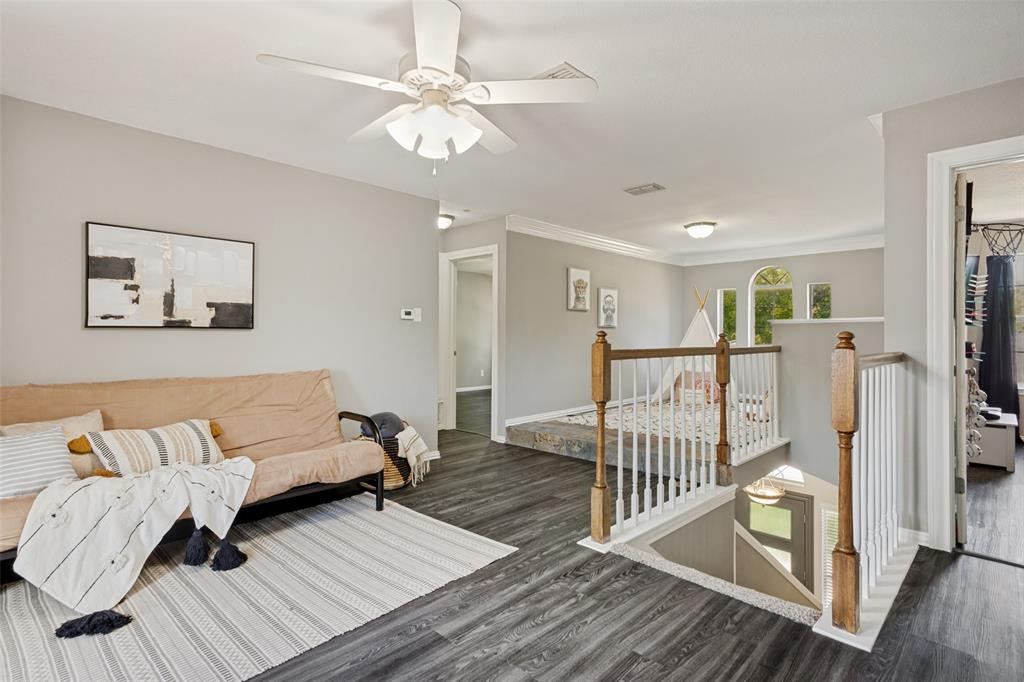 1228 Concho Drive Benbrook, TX 76126 - Photo 24 of 39 Spacious upper-level landing featuring wood-finish flooring, a white ceiling fan, and crown molding