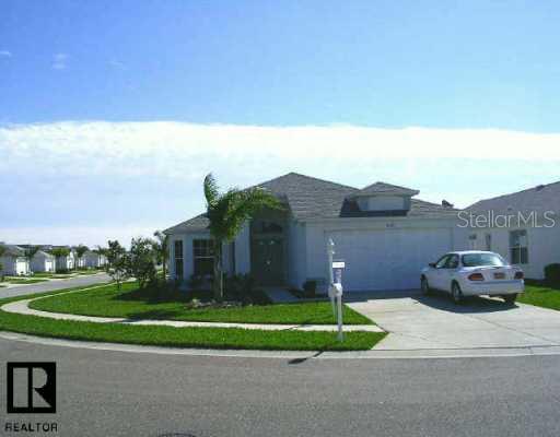 1652 Westerham Loop Trinity, FL 34655 - Photo 1 of 1 a front view of a house with a yard and table and chairs