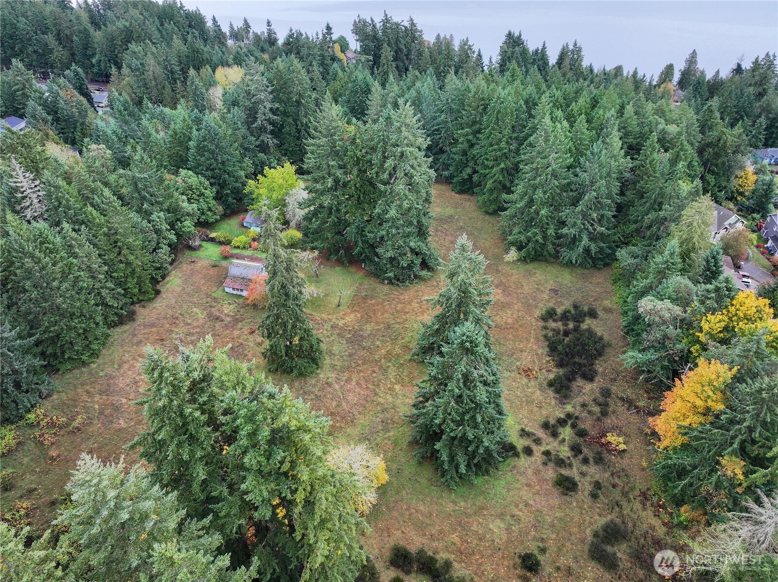 6371 Illahee Road Northeast Bremerton, WA 98311 - Photo 4 of 10 an aerial view of a house with yard and outdoor seating