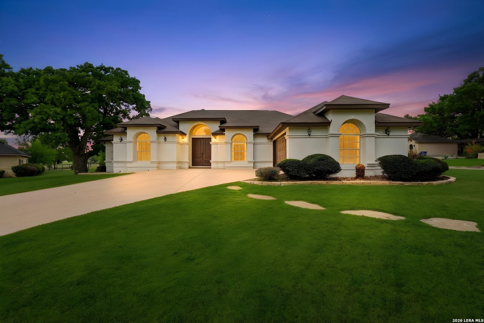 101 Lynx Circle Devine, TX 78016 - Photo 1 of 36 a front view of a house with a garden