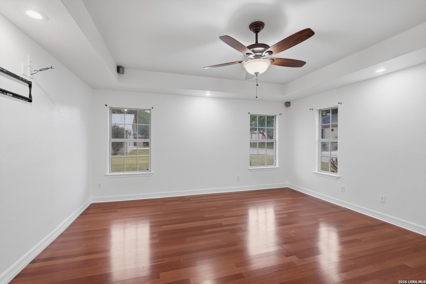 101 Lynx Circle Devine, TX 78016 - Photo 20 of 36 a view of a livingroom with a ceiling fan and wooden floor