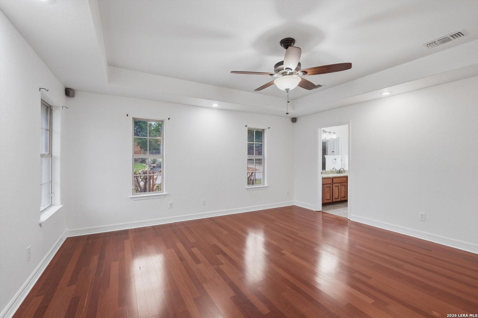 101 Lynx Circle Devine, TX 78016 - Photo 21 of 36 a view of an empty room with wooden floor and a window