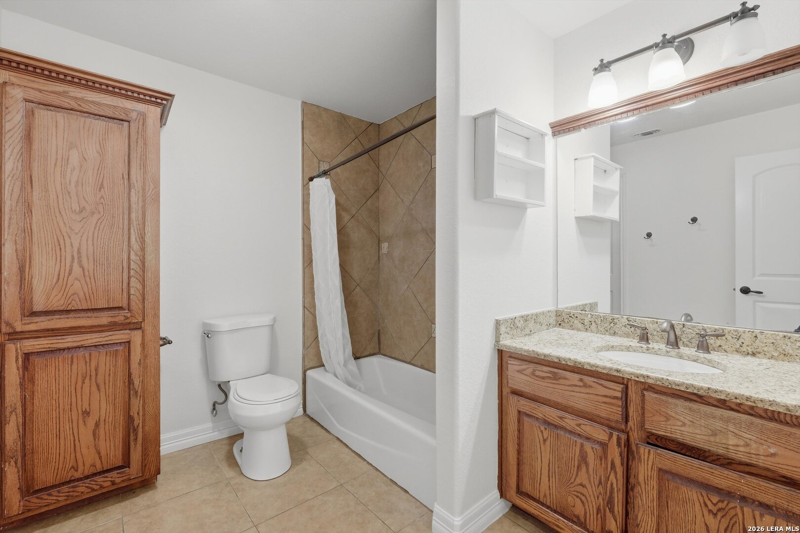 101 Lynx Circle Devine, TX 78016 - Photo 24 of 36 a bathroom with a granite countertop sink toilet and shower