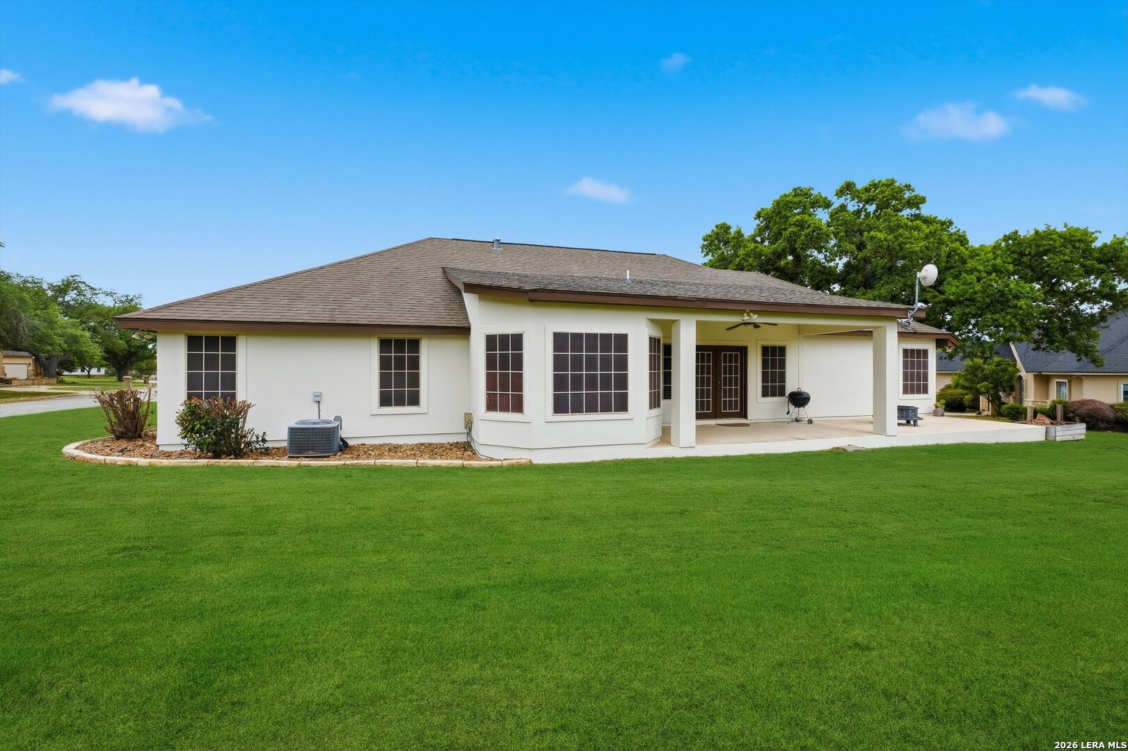 101 Lynx Circle Devine, TX 78016 - Photo 28 of 36 a front view of a house with a garden