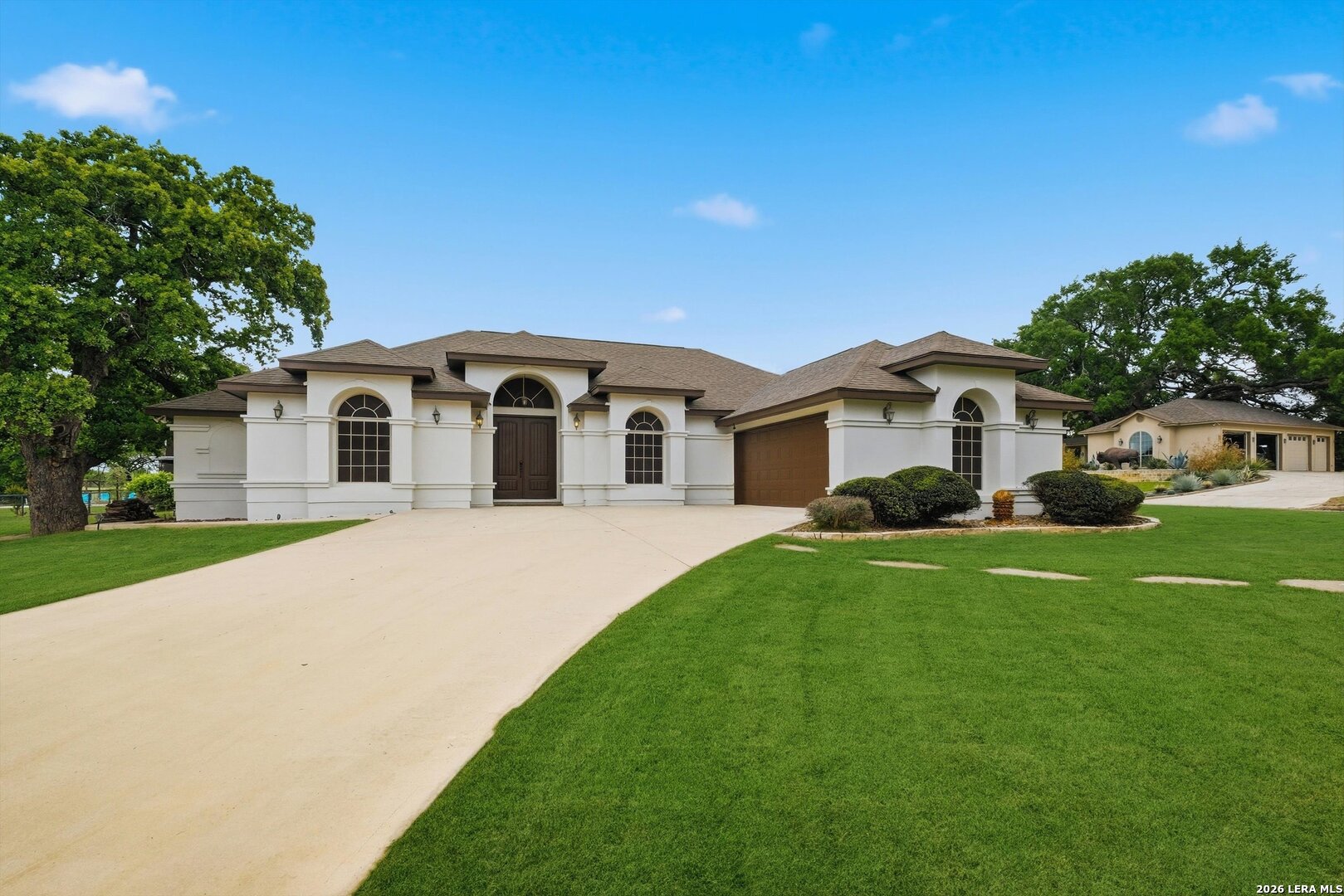 101 Lynx Circle Devine, TX 78016 - Photo 3 of 36 a front view of a house with a garden