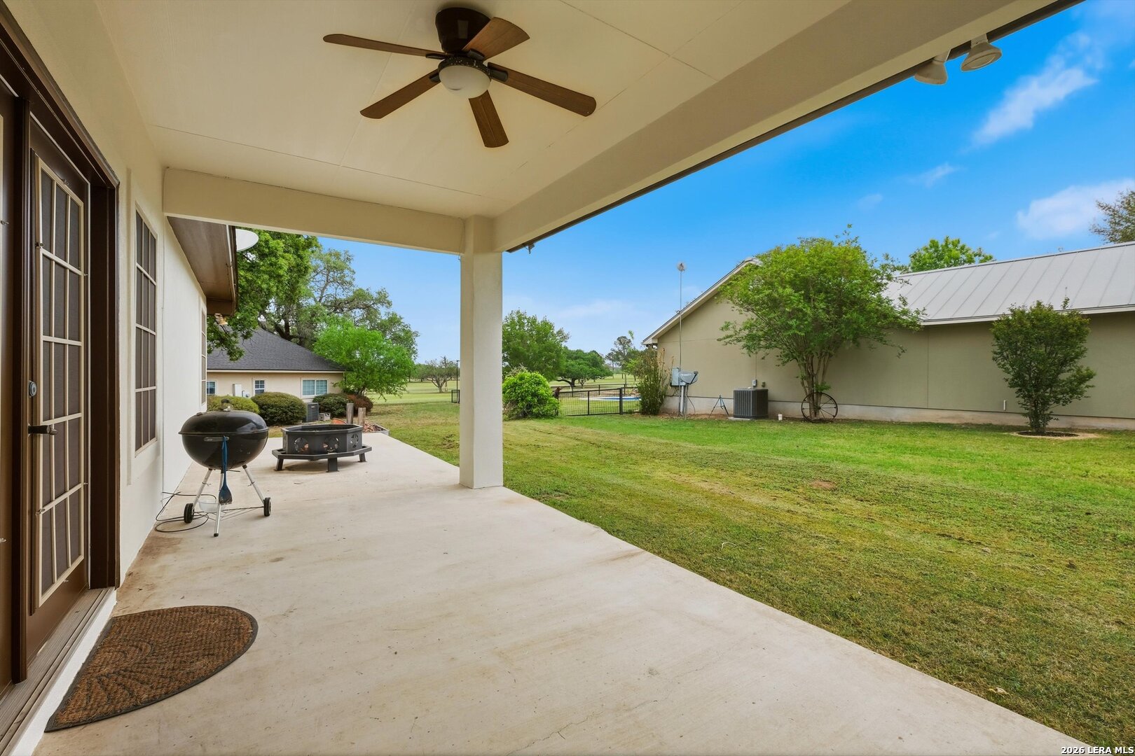 101 Lynx Circle Devine, TX 78016 - Photo 34 of 36 a view of a patio with a table and chairs under an umbrella