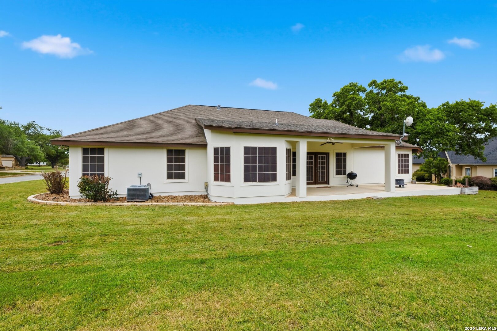 101 Lynx Circle Devine, TX 78016 - Photo 35 of 36 a front view of a house with a garden