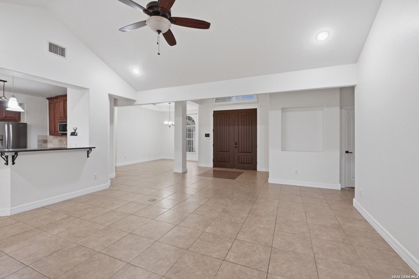 101 Lynx Circle Devine, TX 78016 - Photo 8 of 36 a view of an empty room and kitchen view