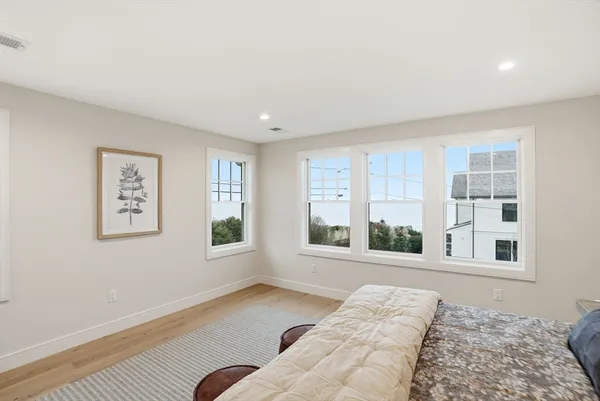 a view of a bedroom with furniture and windows