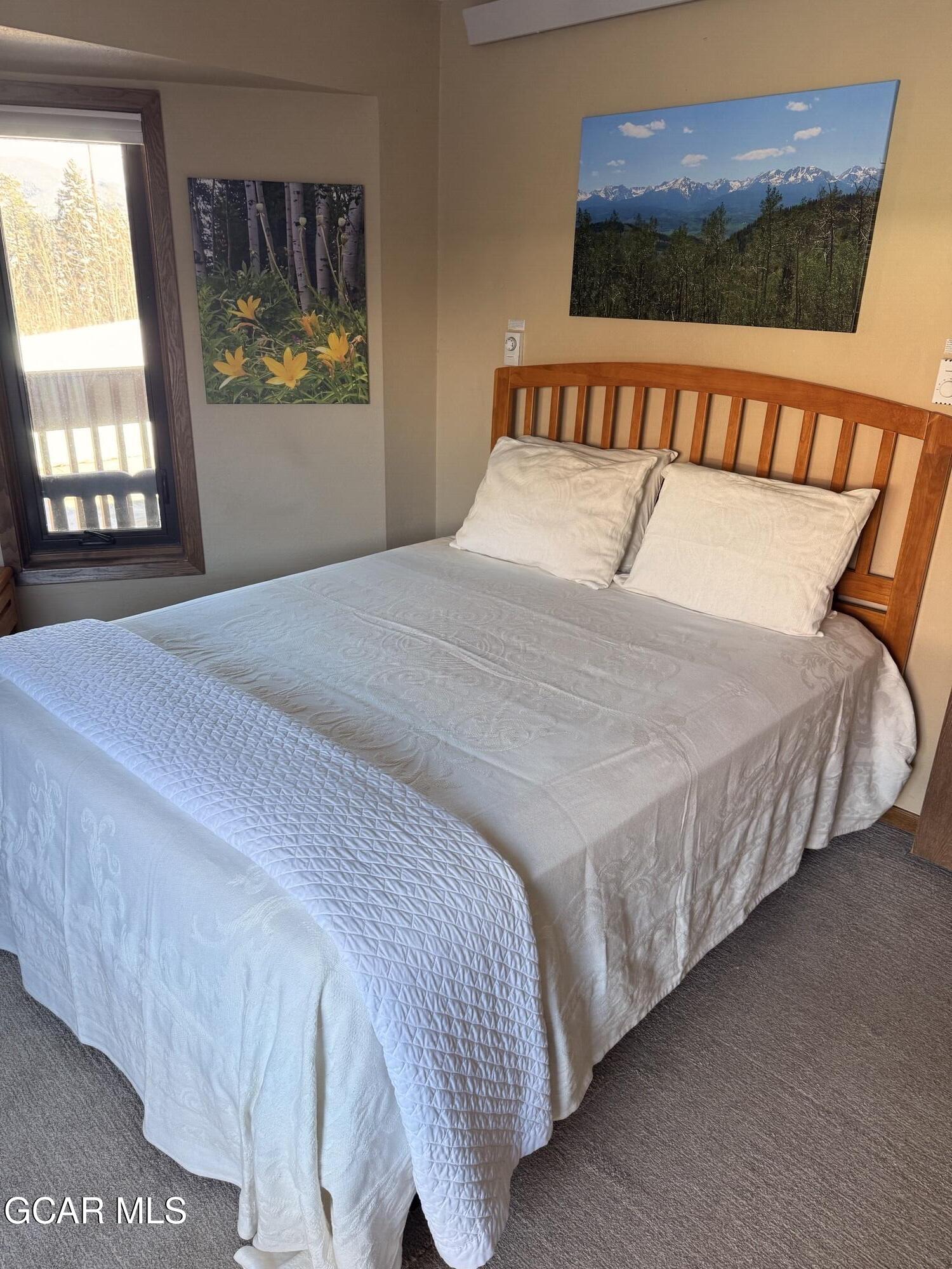 490 Kings Crossing Road, Unit 611 Winter Park, CO 80482 - Photo 27 of 39 a bedroom with a bed and window
