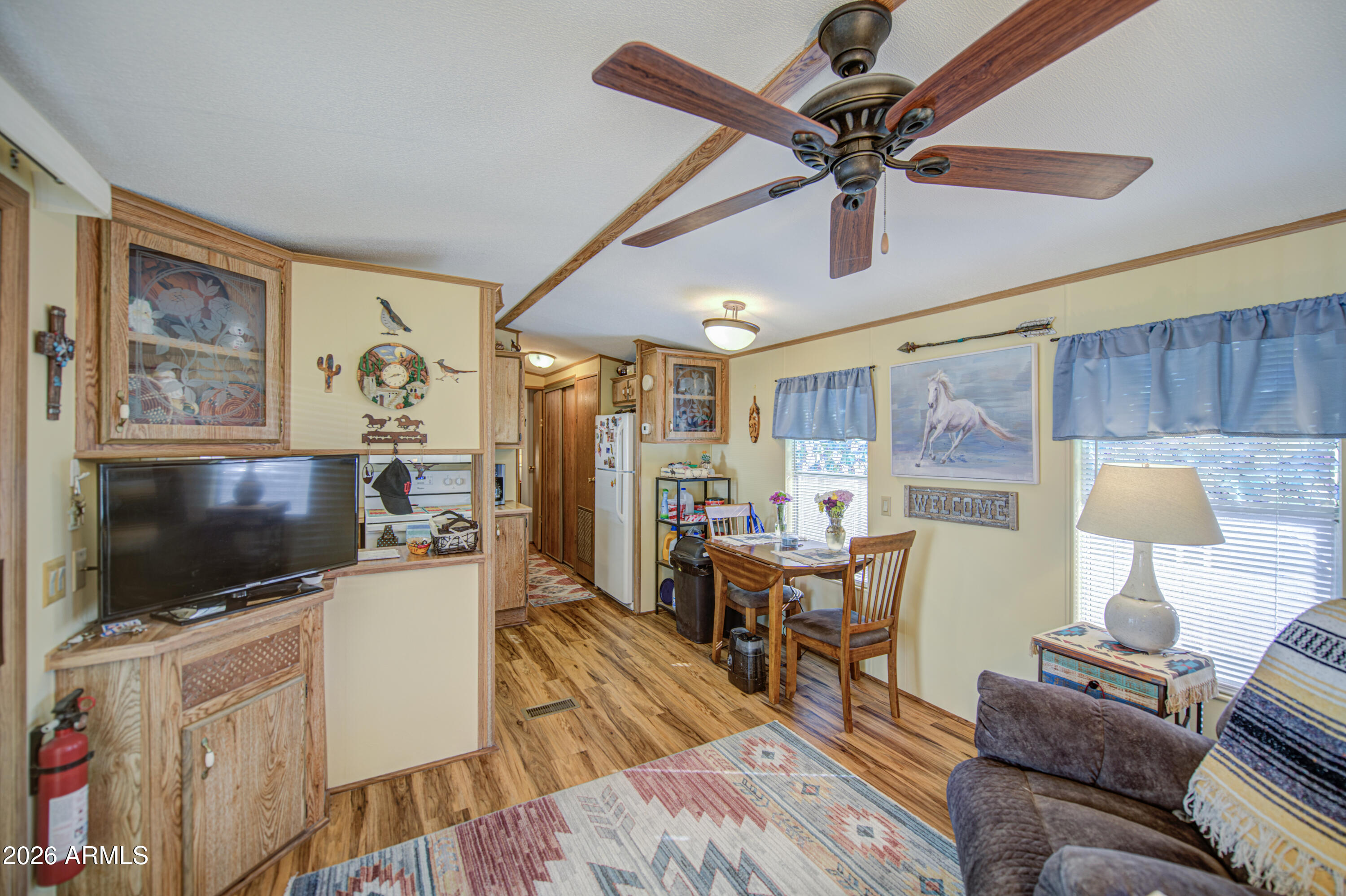 7750 East Broadway Road, Unit 463 Mesa, AZ 85208 - Photo 11 of 36 a living room with furniture and a flat screen tv