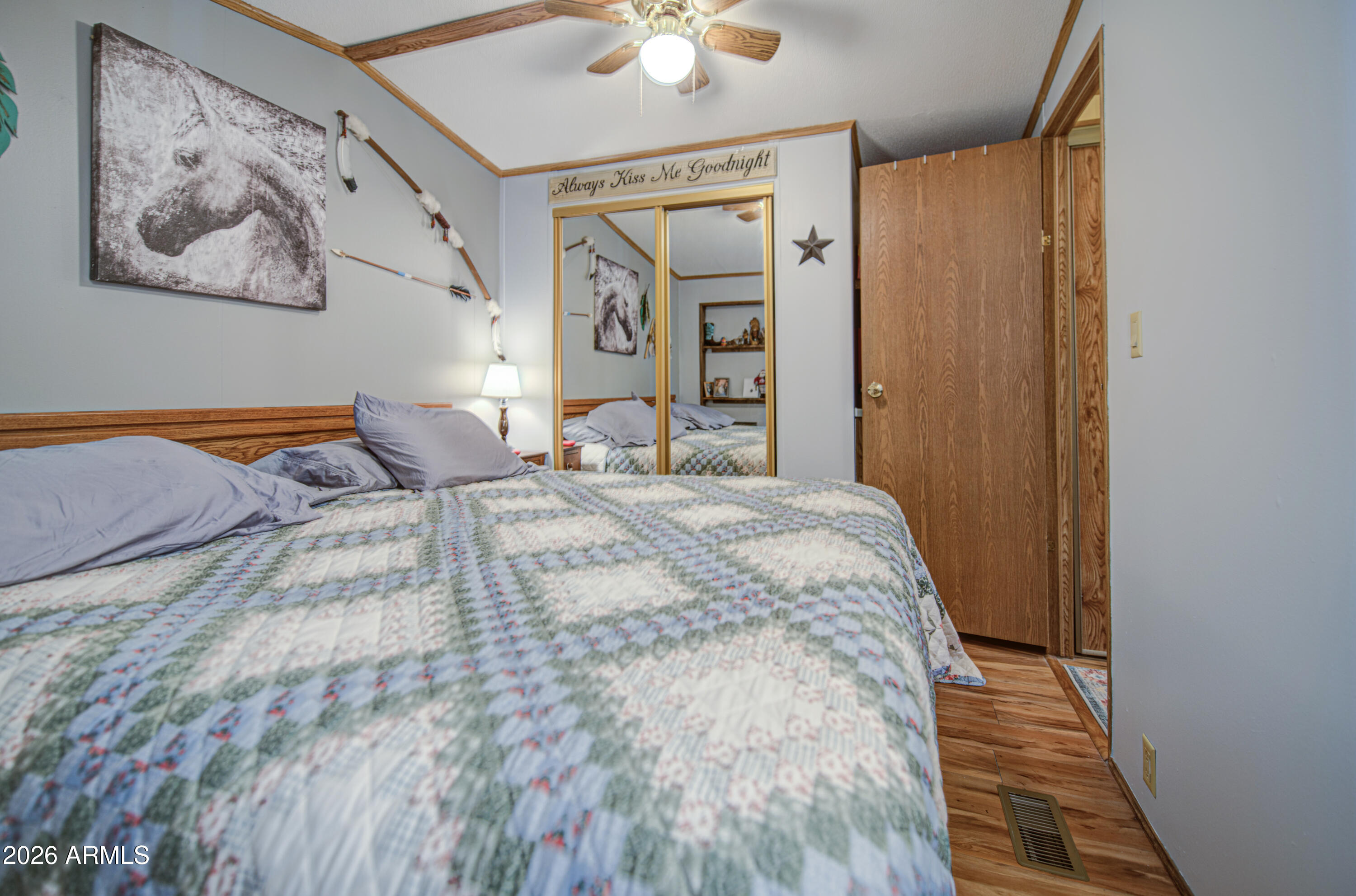 7750 East Broadway Road, Unit 463 Mesa, AZ 85208 - Photo 12 of 36 a bedroom with a bed and a painting on the wall