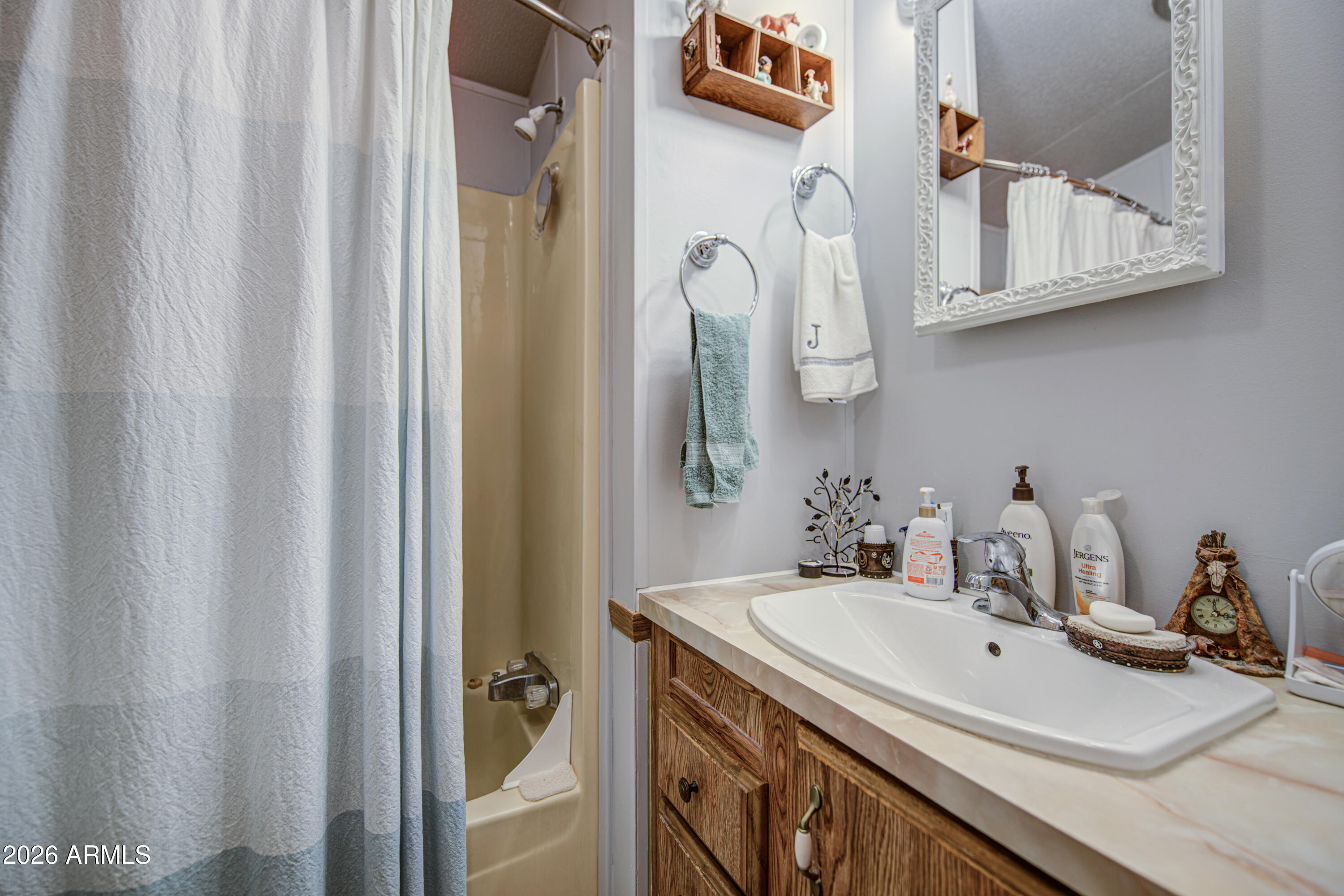 7750 East Broadway Road, Unit 463 Mesa, AZ 85208 - Photo 14 of 36 a bathroom with a sink and a mirror
