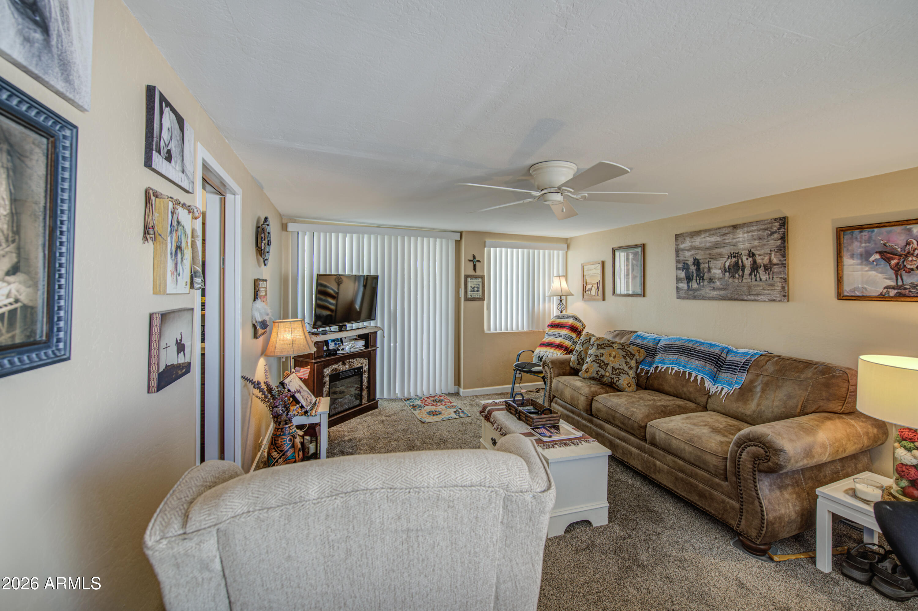 7750 East Broadway Road, Unit 463 Mesa, AZ 85208 - Photo 16 of 36 a bedroom with furniture and a flat screen tv