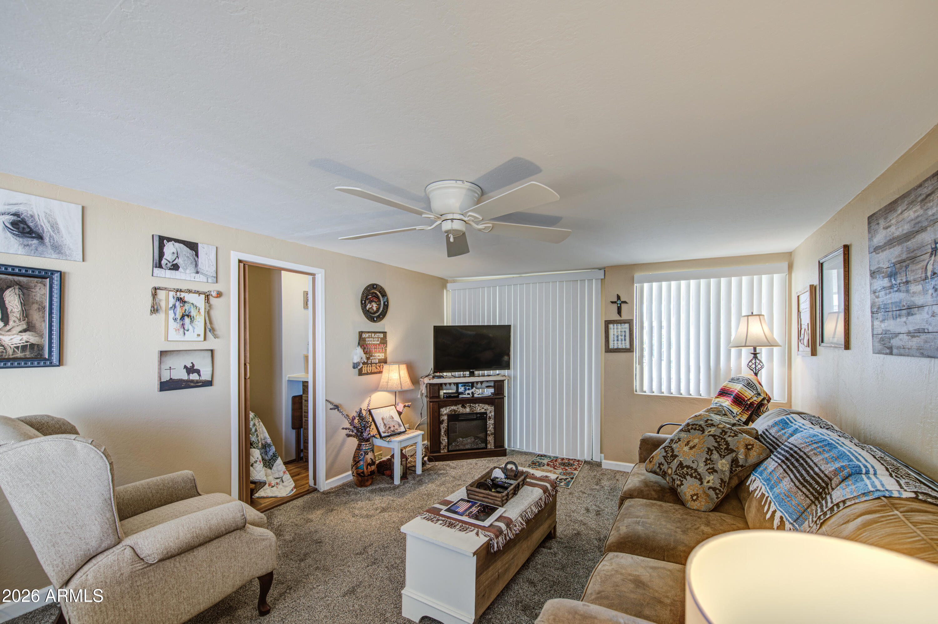 7750 East Broadway Road, Unit 463 Mesa, AZ 85208 - Photo 17 of 36 a living room with furniture a flat screen tv and a window