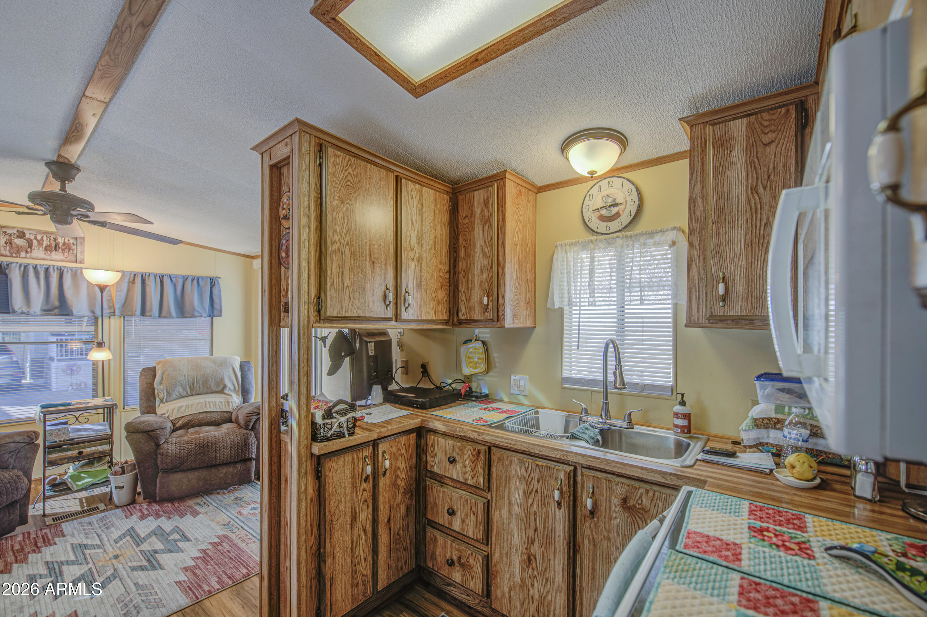 7750 East Broadway Road, Unit 463 Mesa, AZ 85208 - Photo 7 of 36 a kitchen with a refrigerator and a sink