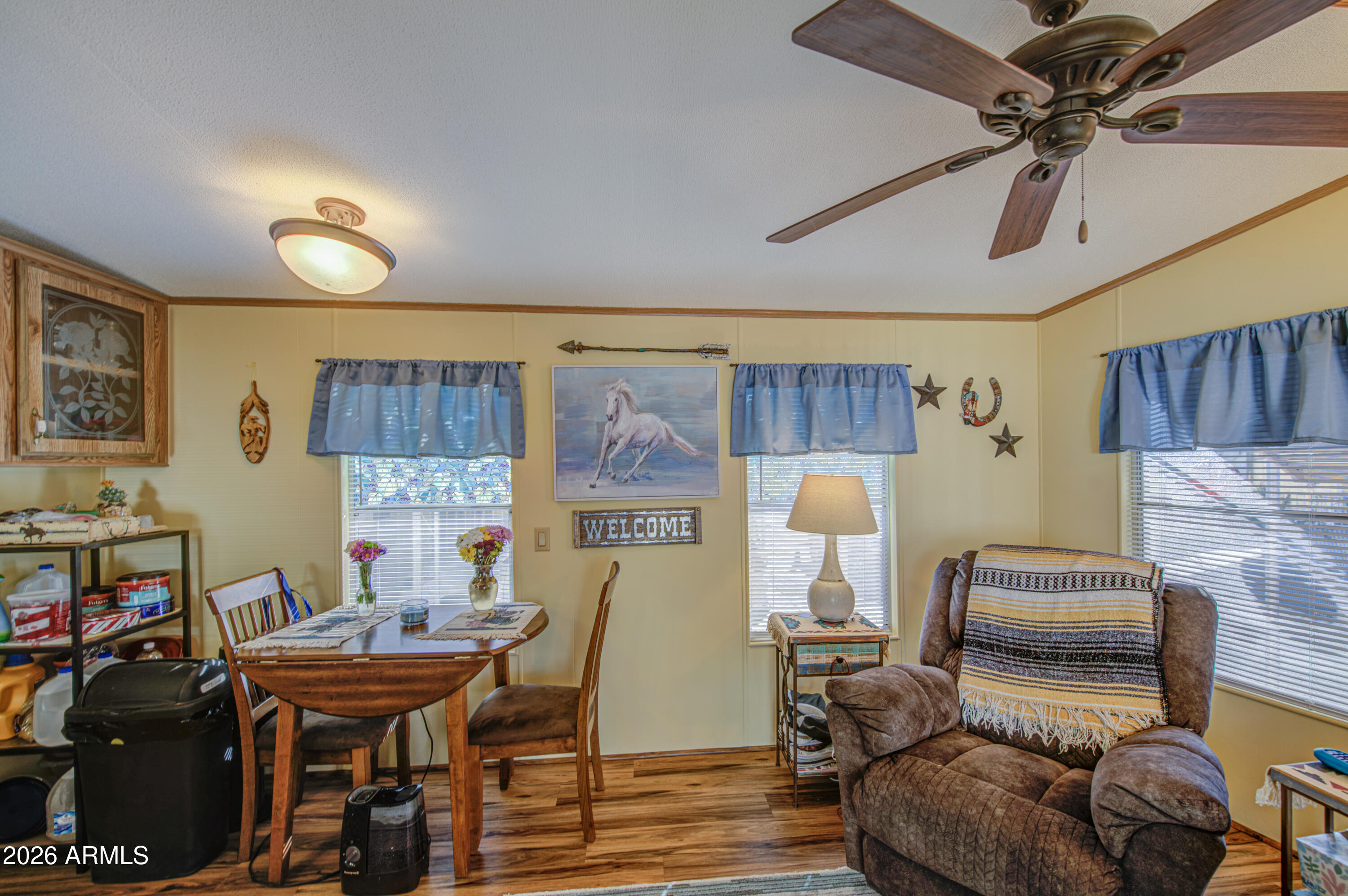 7750 East Broadway Road, Unit 463 Mesa, AZ 85208 - Photo 8 of 36 a living room with furniture and a wooden floor