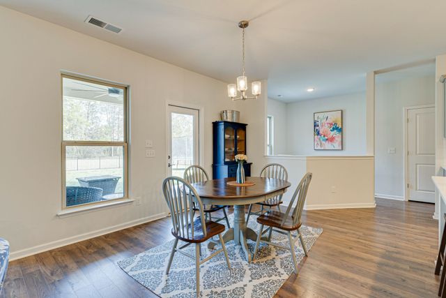 a view of a dining room with furniture wooden floor and chandelier