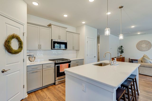 a kitchen with a stove a sink and a refrigerator